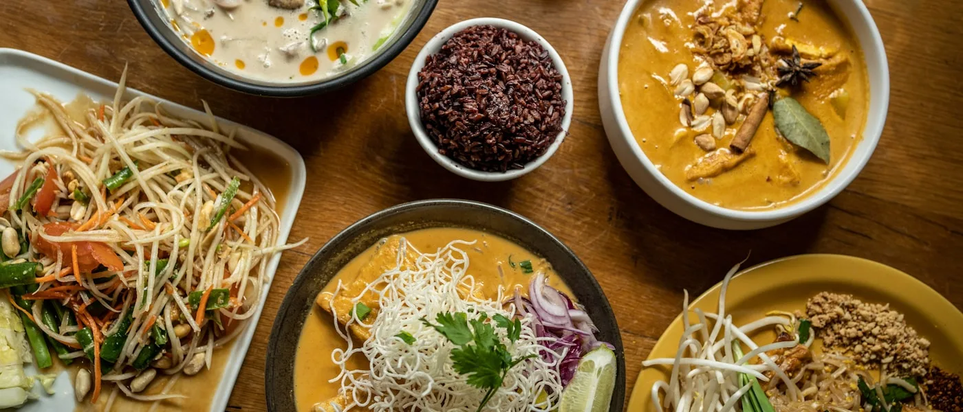 Thai dishes spread across a table